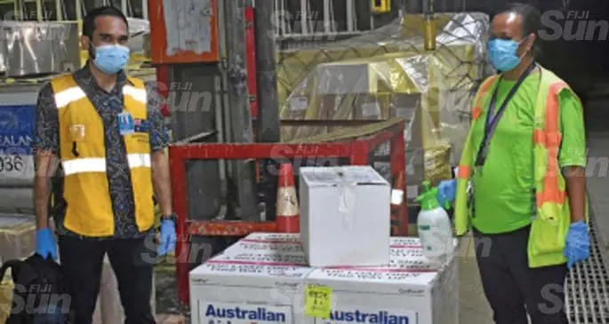 Australian Border Force, Regional Borders Training Officer (Pacific) Michael Chandrasegaran hands over the consignment to senior health officer Luisa Tigarea at the Nadi International Airport on May 14, 2021. Photo: Waisea Nasokia
