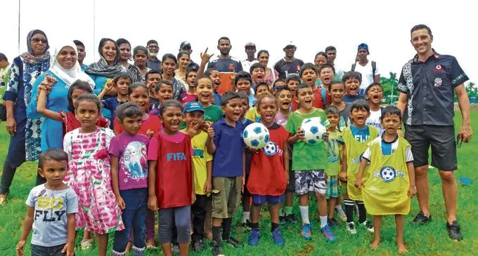 Vodafone Fijian football head coach Christophe Gamel with Mom N Pop participants.  Photo: Fiji FA Media