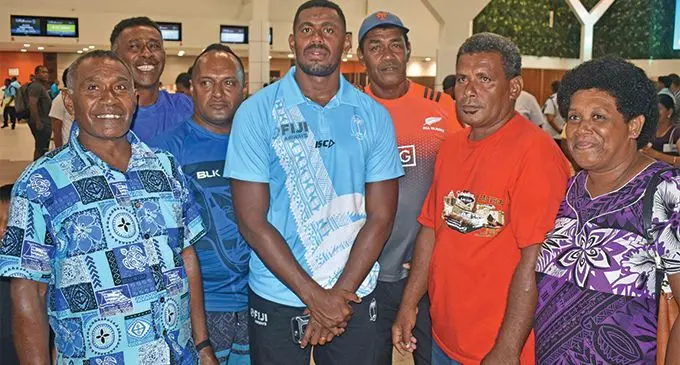 Fiji Airways Fijian 7s captain Kalione Nasoko (middle) with relatives at the Nadi International Airport on February 22, 2019. Photo: Waisea Nasokia