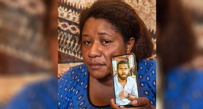 Selina Liku holds a photo of her late husband Luke Erenavula at their village in Naimasimasi, Serua on July 3, 2022. Photo: Leon Lord