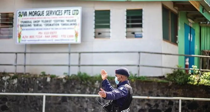 Police constable Terio Tamani directing traffic outside the mortuary at the Colonial War Memorial Hospital after they cordoned it off due to the movement of people around the area on 21 July 2021. Photo- Leon Lord