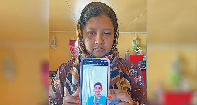 Rihan Ali’s mother, Imrana Ali, holds her son’s photo on the day of his funeral.