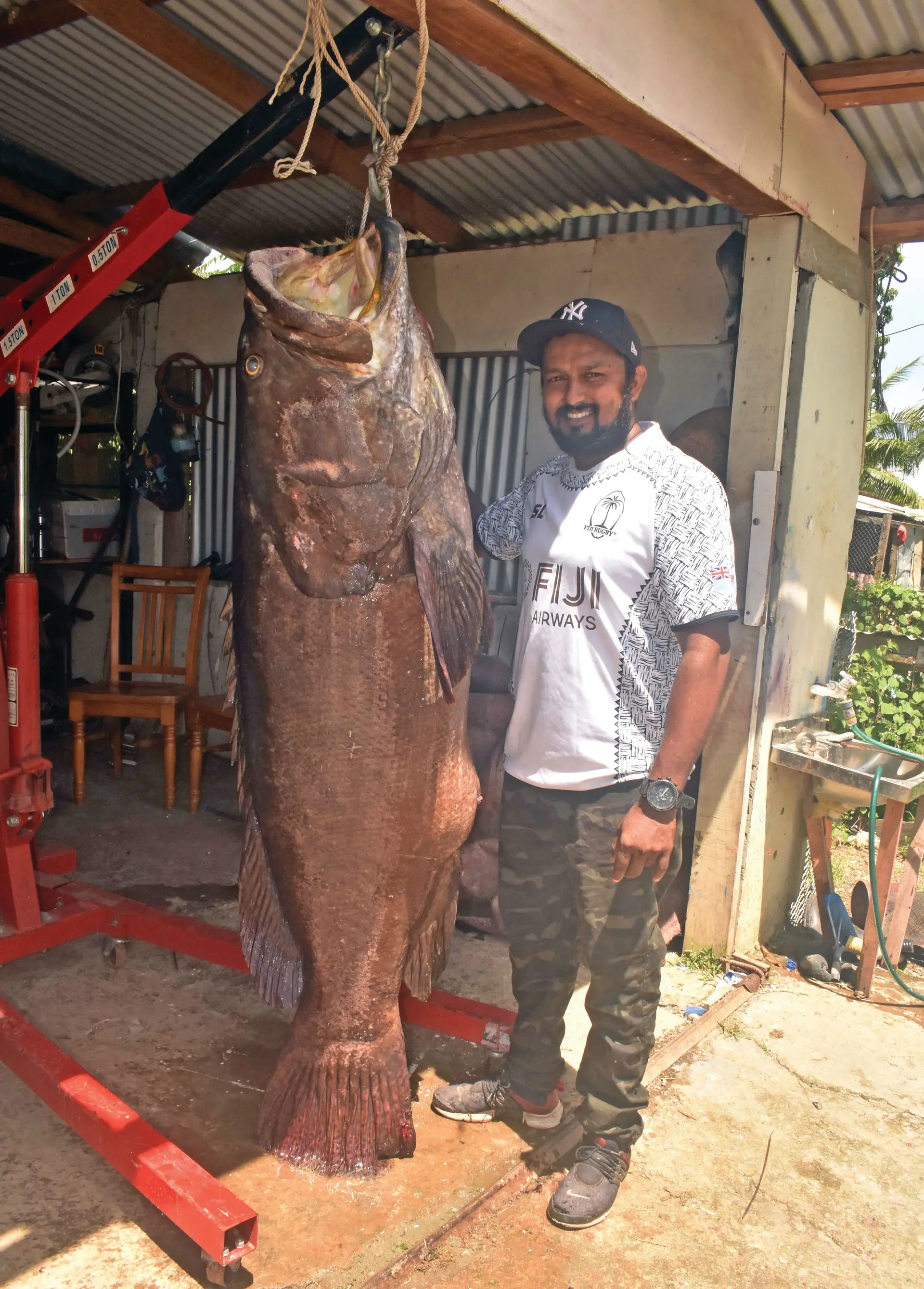 Fisherman Dineshwar Reddy with the huge Kawakawa fish at his home in Sonaisali, Nadi yesterday. Photo: WAISEA NASOKIA