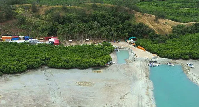 Construction work at the proposed resort site on Malolo Island.   INSET: Before the construction work.  