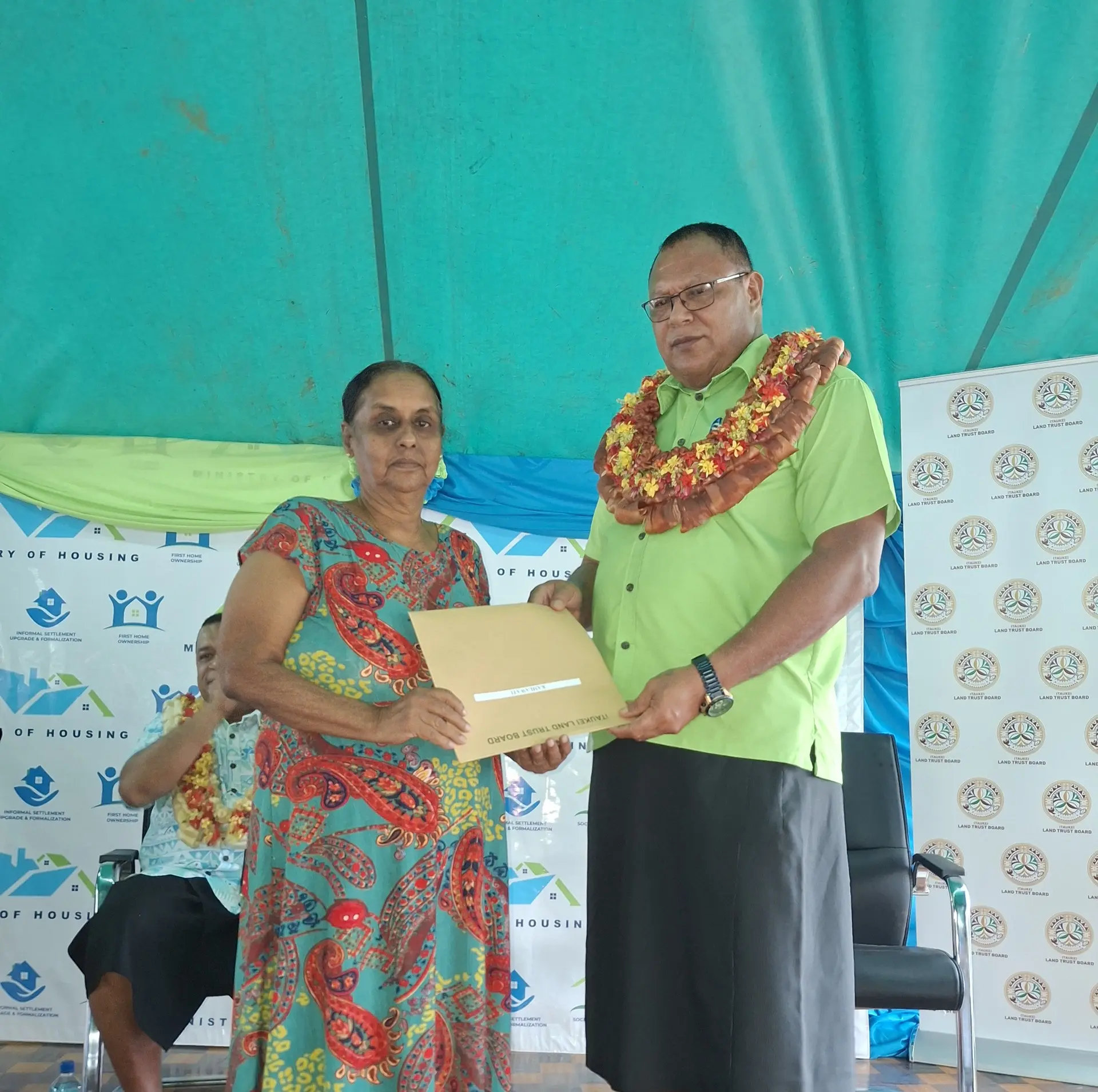 iTaukei Land Trust Board chief executive officer Solomone Nata hands over the lease title to Kamla Wati at Ledusasa Settlement, Votualevu, Nadi.