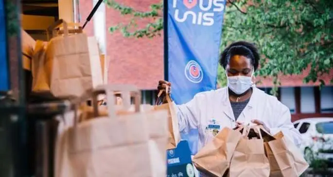 A medical worker gets free food from a food truck in Paris, France, April 15, 2020. (PSG/Handout via Xinhua)