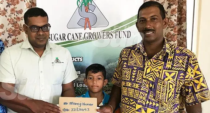 Farmer Monaj Kumar receives his $3,000 cheque from the FijiCare Insurance Limited. Photo: Shratika Naidu 