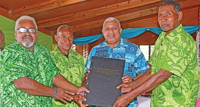 The Prime Minister Voreqe Bainimarama holds the document on the Transfer of Freehold Buyback Land to Yavusa Navusa under the Government Freehold Buy-Back Scheme   LAND TITLE with the land stakeholders at Welagi, Taveuni, on March 14, 2019. Photo: DEPTFO News