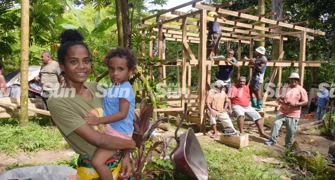 Jessie Liku with son, Epineri Vula (jr) are all smiles as members of  Global Awakening Prayer &amp; Healing Ministry are building a house for her and her children on after reading her story in Fiji Sun on January 27, 2022. Photo: Ronald Kumar.