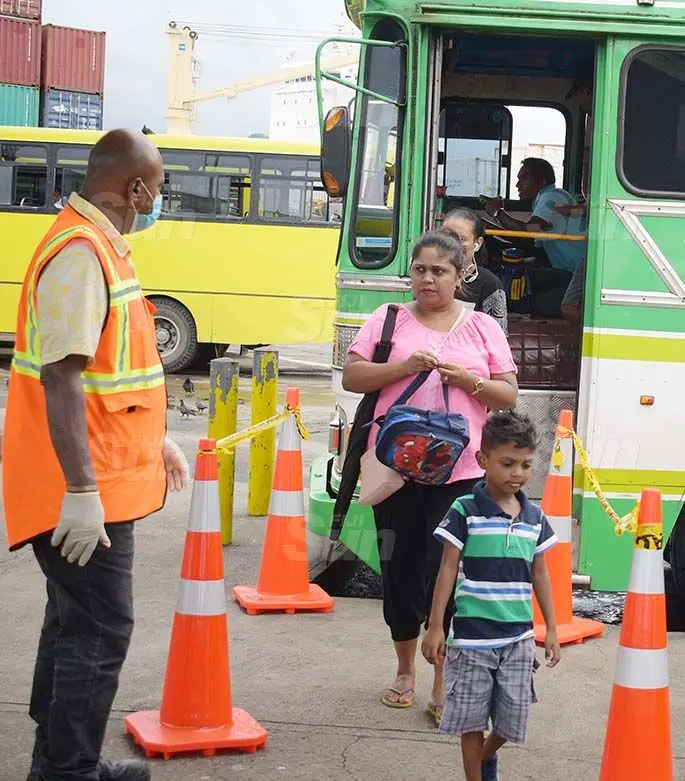 Suva City Council enforcement officer Jope Kete (left) monitors people’s movement at Suva bus stand as cone been placed at the bus stand for people to practice social distancing on March 31, 2020. Photo: Ronald Kumar.