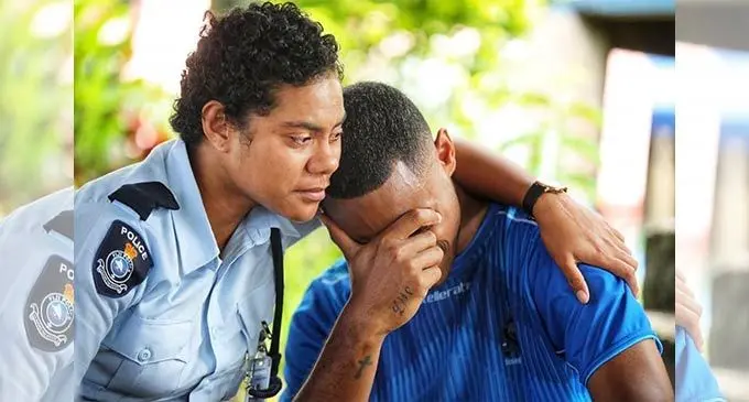 A Police Officer comforts Police Constable Epineri Tunidau, the son of the late Laisa Maraia Waka, who was recently killed in Sockburn, New Zealand. Photo: Police Media Cell