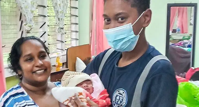 Sristi Naicker and her newborn daughter with a  National Fire Authority officer at the Rakiraki Hospital on January 9, 2022. Photo: National Fire Authority