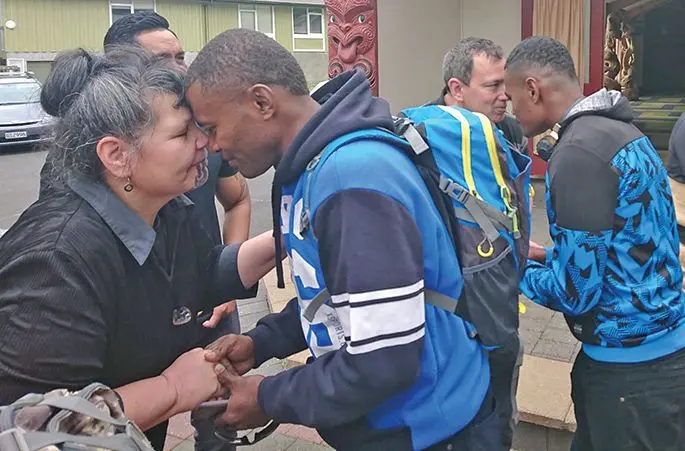 The members of the tour group being welcomed by members of the local Maori community in the traditional ceremony of Hongi.