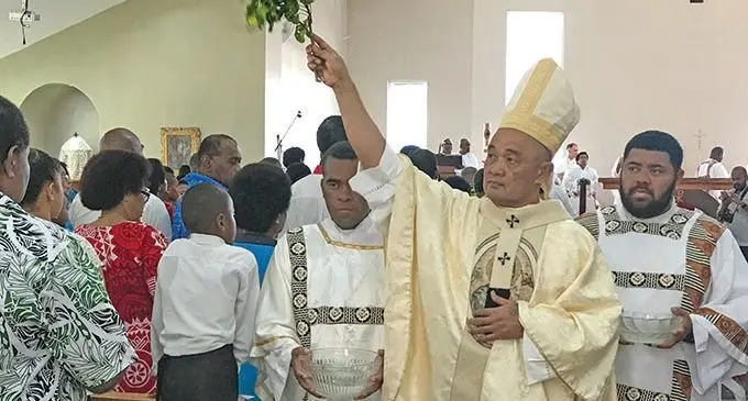 His Grace Archbishop Peter Loy Chong sprinkles holy water on the congregation during the opening of the Our Lady of Perpetual Help Parish church in Lautoka on August 24, 2019.