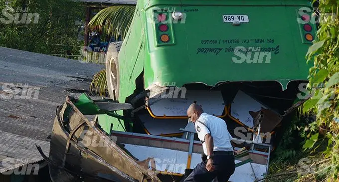 Two students died after this school bus slipped off the road and landed on a house at Lakena Hill in Nausori on October 9, 2019.  Photo: Ronald Kumar