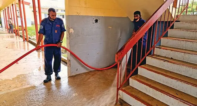 National Fire Authority (NFA) officers during the clean-up of the school after evacuees returned home on Januray 11, 2022. Photo: Sampras Anand