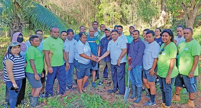 (Third from left) Ministry of Forestry Forest Guard Leveni Duvuduvukula, Sugarcane Growers Fund Information Technology Support officer and company green champion Salanieta Nalotawa (sixth from left) and chief Sugarcane Growers Fund Chief Executive Officer Raj Sharma hold a soursop seedling with staff and members of the Ministry of Forestry  at the Agroforestry plot in Lololo, Lautoka on September 17, 2022. Photo: Salote Qalubau
