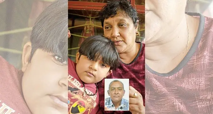 Roslyn Devi, 55, with her grandson Reshap Kumar at their Nausori home with a picture of the late Satya Pillay on September 28, 2021.  Photo: Ronald Kumar.  