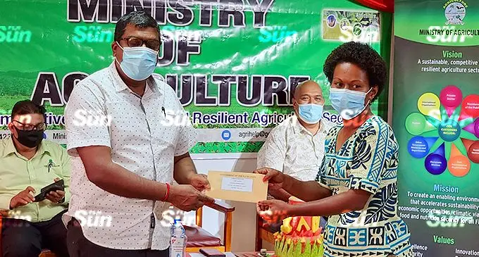 Veilomani Duavata women’s Group representative, Asenaca Macawai receives her offer letter from Minister of Agriculture, Environment and Waterways, Mahendra Reddy in Labasa on November 23, 2021. Photo: Sampras Anand.