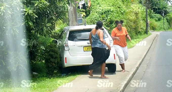 The two female occupants of this rental car (pictured above) escaped injuries after the driver (right) lost control of the car and collided with a EFL power post as she drov out of Nasinu Road onto the quuen highway in Nasinu on December 28, 2021. Photo: Ronald Kumar.