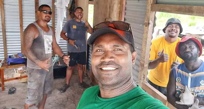 Bryan Wale (third from left), Eugene Gavibatu (fifth from left)and the rest of their team in front of the house they built for an elderly couple who lost their home to severe TC Yasa.