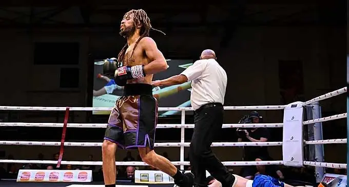 Zain Adams of Peach Boxing in New Zealand runs to the neutral corner after knocking Patthaphi Camton out cold in the second round of their fight on December 2, 2023.