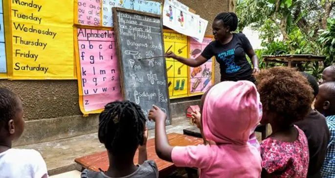 Kindergarten teacher Juliet Namanda teaches children at her home in Kampala, capital of Uganda, June 19, 2020. (Xinhua/Hajarah Nalwadda)