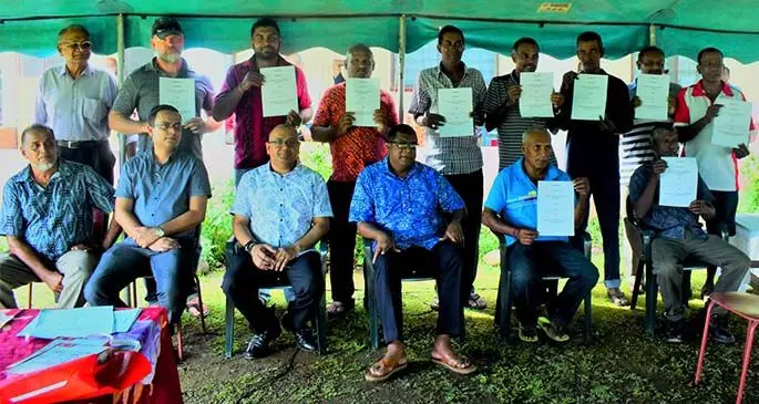 Agriculture Minister Mahendra Reddy (sitting fourth from left), Permanent Secretary of Agriculture Ritesh Dass and Agriculture Marketing Authority chief executive officer Alvin Sharma with the pioneering contractual farming Sabeto group of farmers with their signed contracts. Photo: DEPTFO News