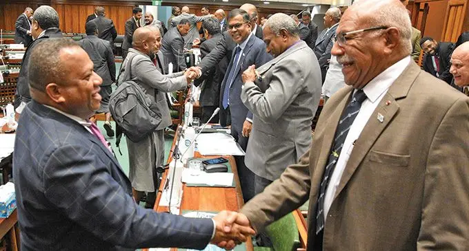 Leader of Opposition Inia Seruiratu and Prime Minister Sitiveni Rabuka celebrate the passing of the 2023-2024 National Budget in Parliament on July 13, 2023. Photo: Parliament of Fiji.