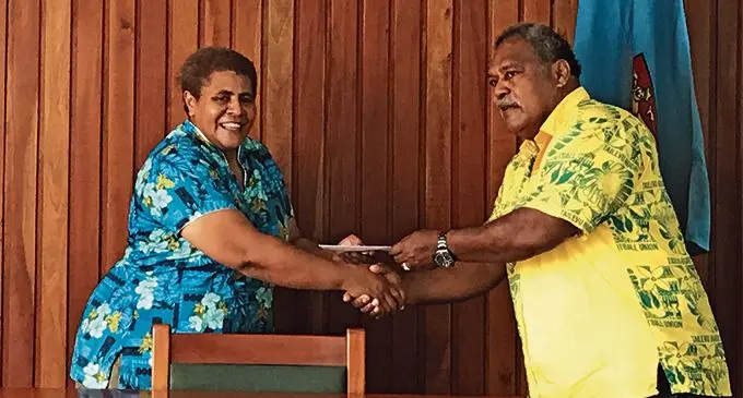 From left Tailevu Holdings Company PTE Limited’s representative Talei Rokotuibau hands over the $1,000 sponsorship Tailevu Rugby Life Member Inoke Qarau.