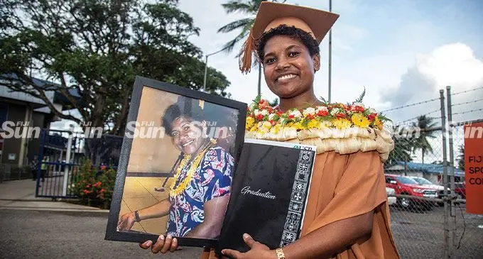 Graduate Josivini Waiwalu holds a photo of her late mother (Jowana Nasakure) after the University of the South Pacific graduation at the FMF Gymnasium, Laucala Bay, Suva on May 12, 2022. Ms Waiwalu dedicated her graduation to her mother who she referred to as her ‘queen’. Photo: Leon Lord