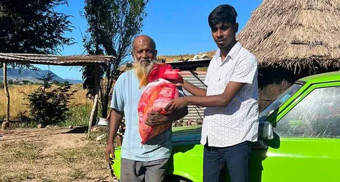 One Nation Our People Youth Club founder and president, Abdul Zorhab (right) after donating groceries to Sheik Sokhat Ali at his home in Nasau, Nadi