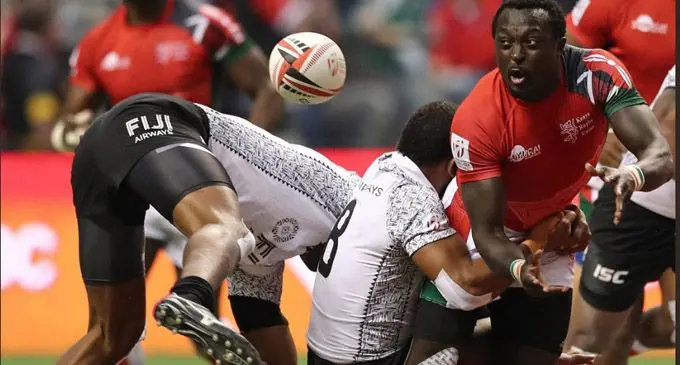 Kenya’s Collins Injera looks for support as he is tackled by Kalione Nasoko during their final pool match of the Canada Sevens in Vancouver on March 12, 2018.  Photo: World Rugby