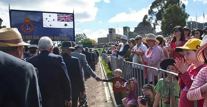 Crowds line the route of the Anzac Day National Ceremony march, 25 April 2011. Photo: Australian War Memorial