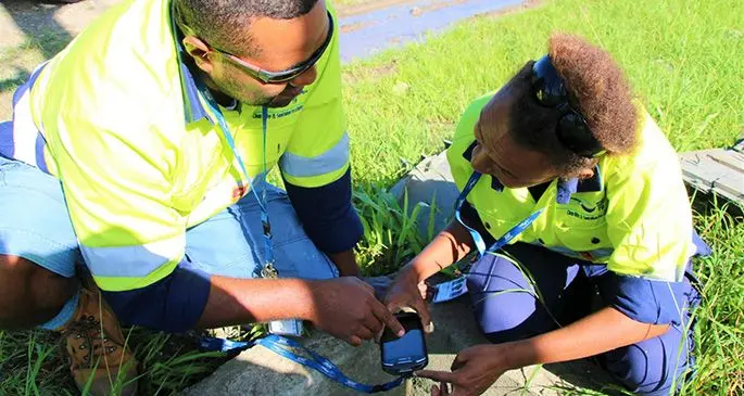 WAF meter readers Tomasi Tuimavana and Emele Vakacegu use the new smart hand-held meter reading device. Source: WAF