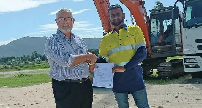 Naisoso Island And Realcorp developer and owner Bob Lowres (left) handing over the $3 million civil contract to Mohammed Iqbal of M Iqbal Investments. Photo: Charles Chambers