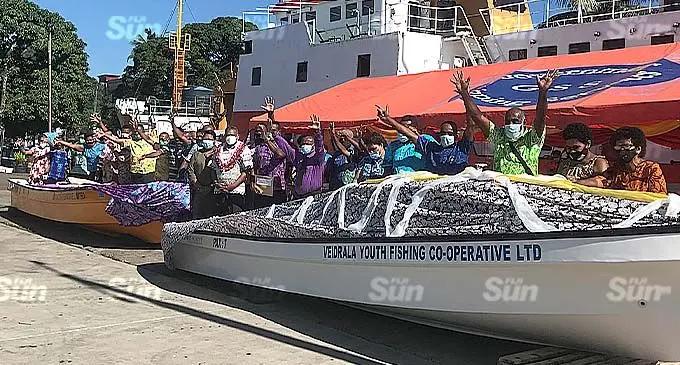 Minister for Commerce, Trade, Tourism and Transport, Faiyaz Koya (wearing a garland) with representatives of Veidrala Youth Fishing Co-operative Limited and Lovu Co-operative Limited, during the handing over of two open boats and engines, at Government Shipping Services, in Walu Bay, Suva, on November 18, 2021. Photo: Frederica Elbourne