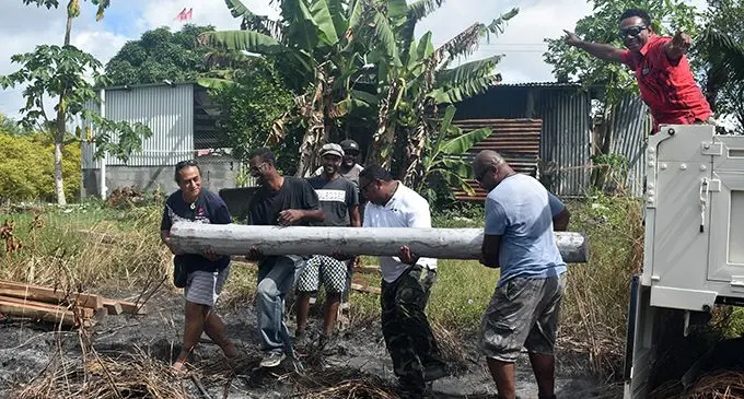 Radio personality, Michael Faga and friends at work in building a proper shelter for Atelaite Koto and her son in Dratabu, Nadi