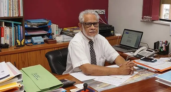 Mr ikbal Jannif CEO, JP, Commissioner of Oath at his desk in Jannif Suva Building.