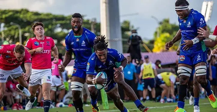 Swire Shipping Fijian Drua winger Selestino Ravutaumada goes over for his second try against the Rebels with Joseva Tamani and Elia Canakaivata in support. The try was disallowed due to an earlier infringement. Photo: Leon Lord