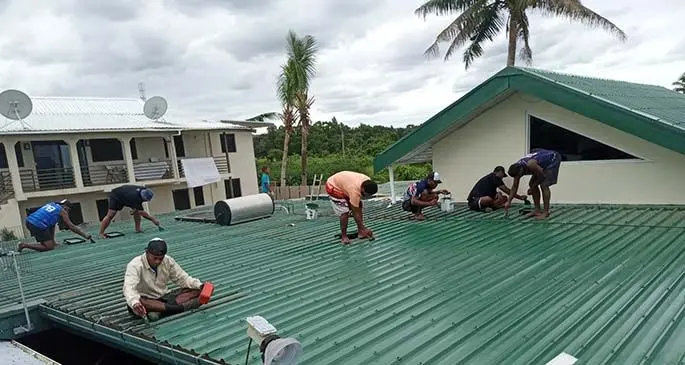 The K9E brothers work on the rooftop of a home in Suva.