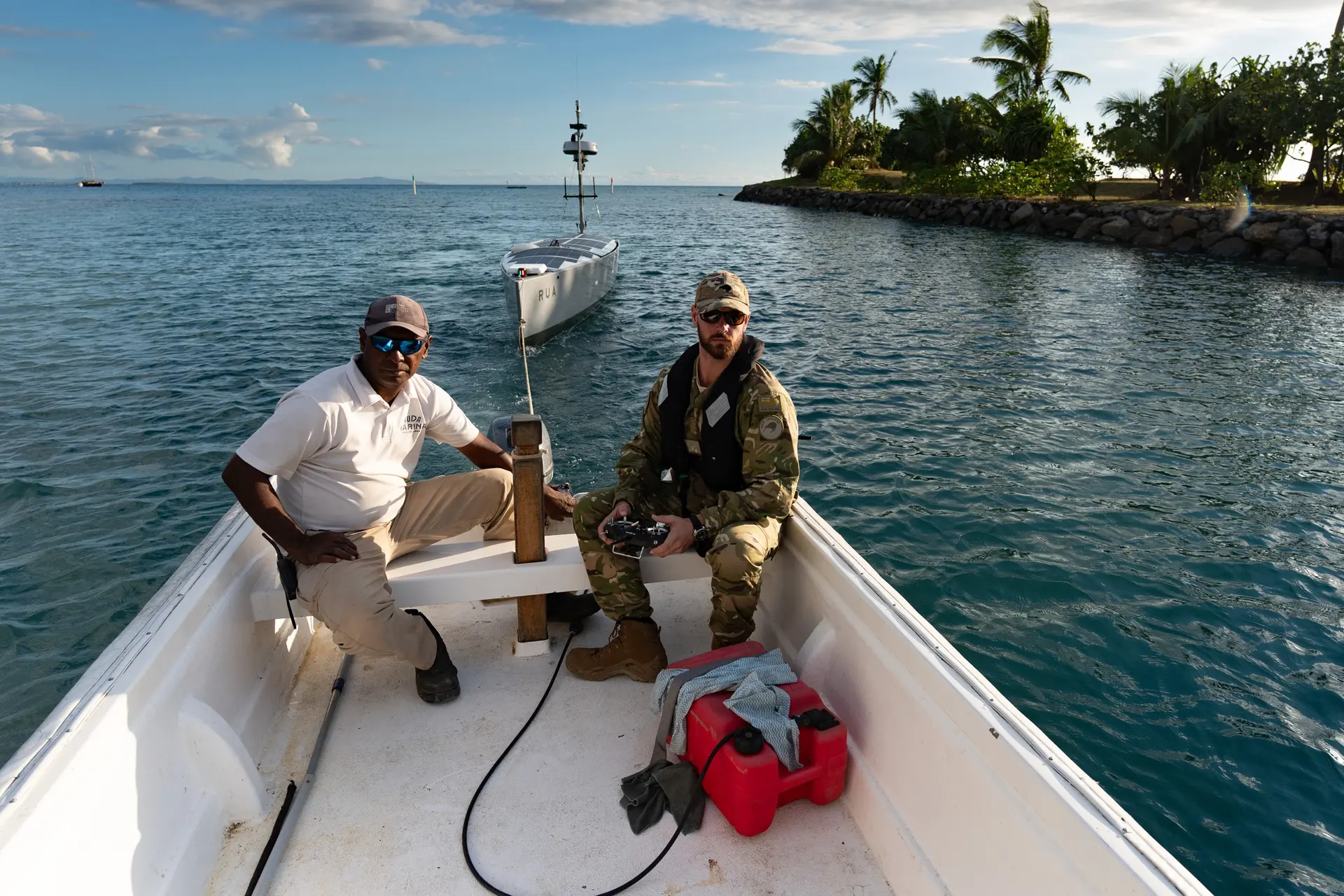  A HMNZS Matataua operator with a Fijian colleague remote-guide a USV back to the shoreline
