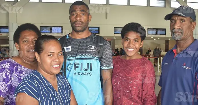 Fijian Drua winger Nacanieli Narekuva with family members at the Nadi International Airport yesterday. Photo: Waisea Nasokia 