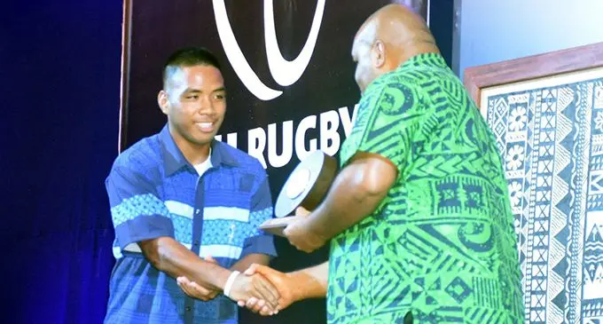 Michael Ofati (left) gets his award from Vodafone  sponsorship manage rAdriu Vakarau during the annual FRU Awards Night at Grand Pacific Hotel, Suva.
