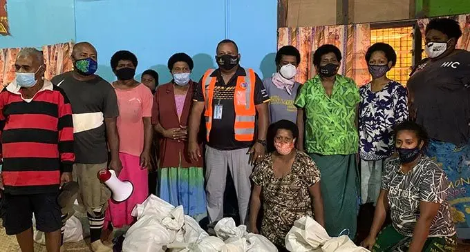Minister for Rural and Maritime Development and Disaster Management Inia Seruiratu (middle) with villagers in Wainibuka after giving their food packs on January 12, 2022. Photo: National Disaster Management Office. 