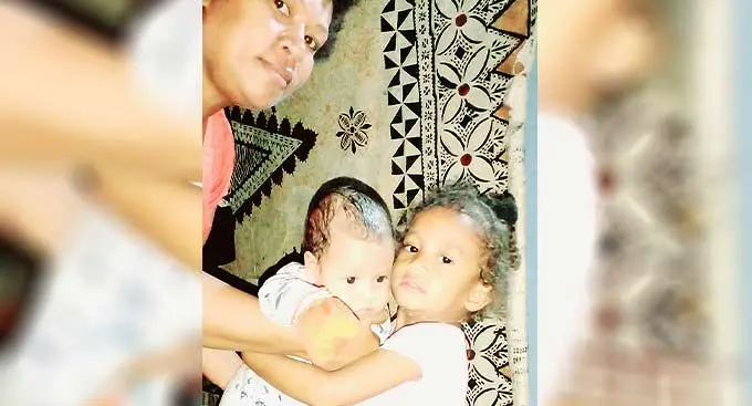 The late, Timoci Kawa Junior (right) holding his younger brother, Eliki alongside his mother, Anatai Baleisuva at their home in Lautoka.