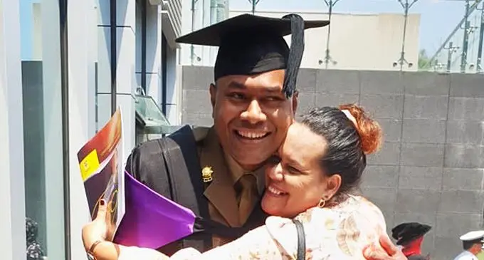 Major Pio Varawa being congratulated by his wife Kelera after the graduation ceremony last week.