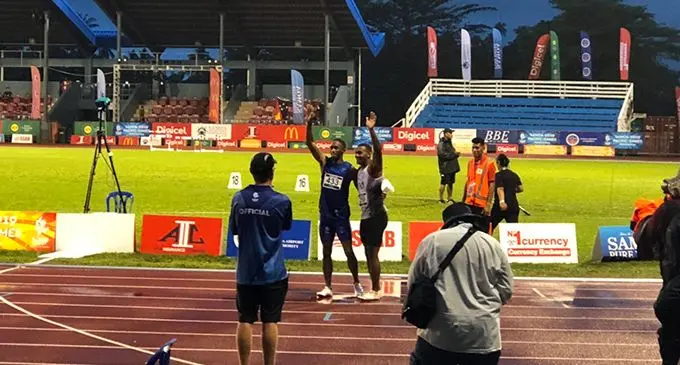 Fiji's Banuve Tabakaucoro and Jeremy Dodson of Samoa wave to the spectators after their race. PHOTO: Rosi Doviverata