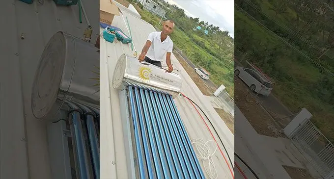Nilesh Chand after installing solar panel at a private residence in Nadi.