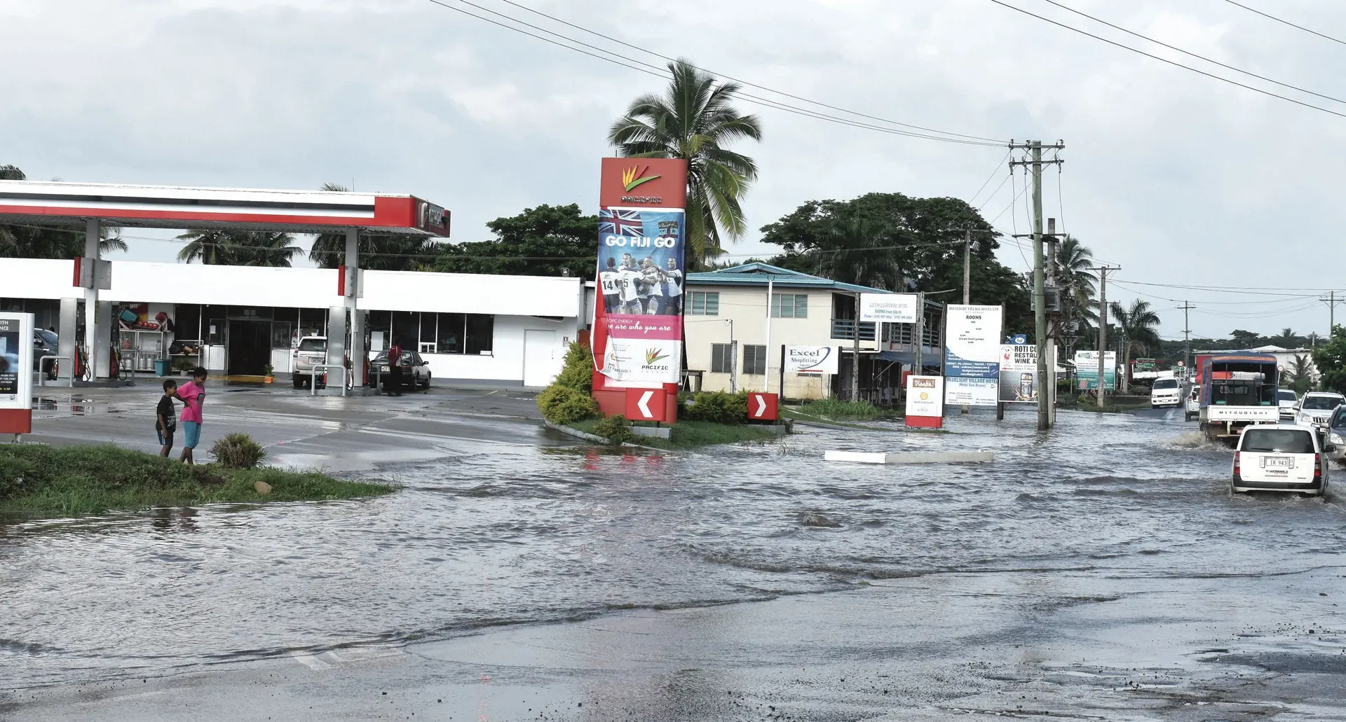 Vehicles try to cross the flooding in Nadi on February 16, 2018. Inset: A flooded Lomawai Village. Photo: Waisea Nasokia